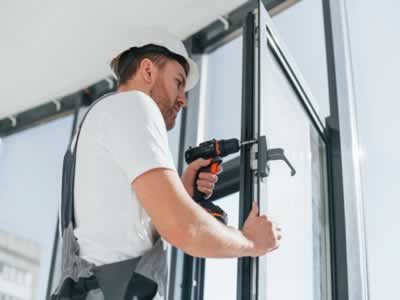 grey-uniform-repairman-is-working-indoors-modern-room grey-uniform-repairman-is-working-indoors-modern-room