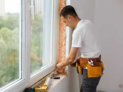 male-industrial-builder-worker-window-installation-building-construction-site male-industrial-builder-worker-window-installation-building-construction-site